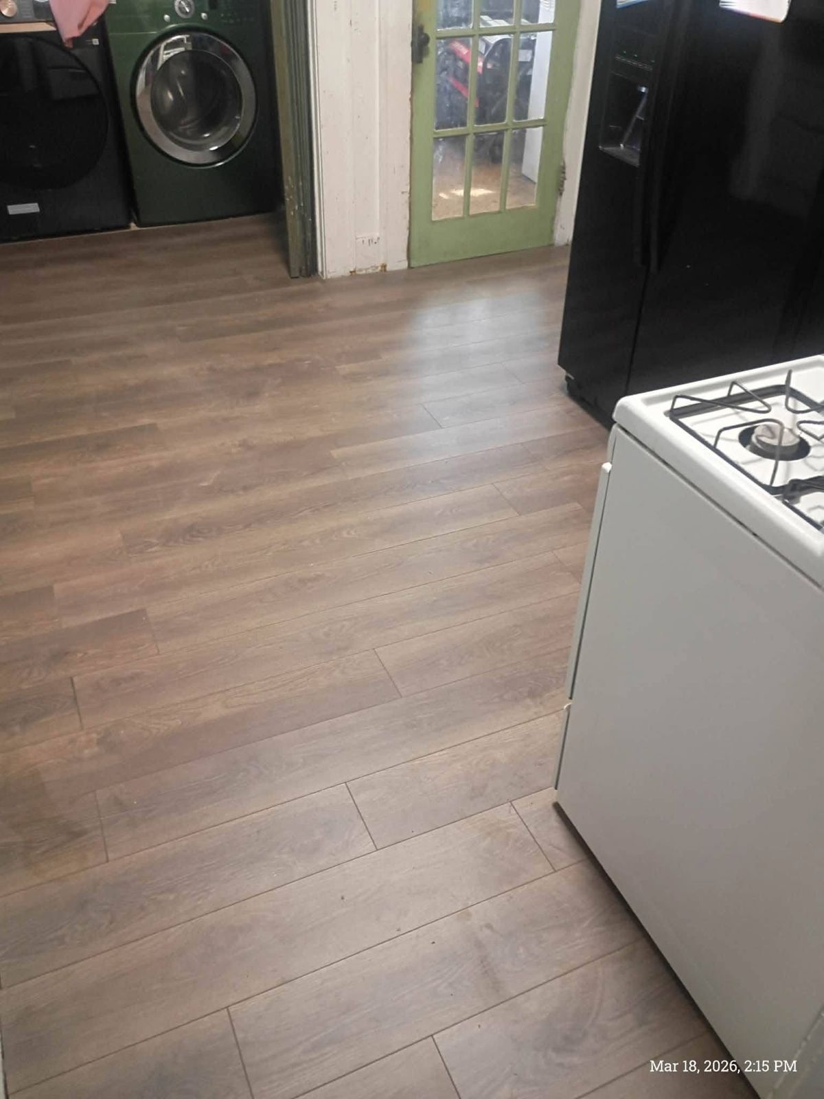 Kitchen floor after: new wood-look plank flooring