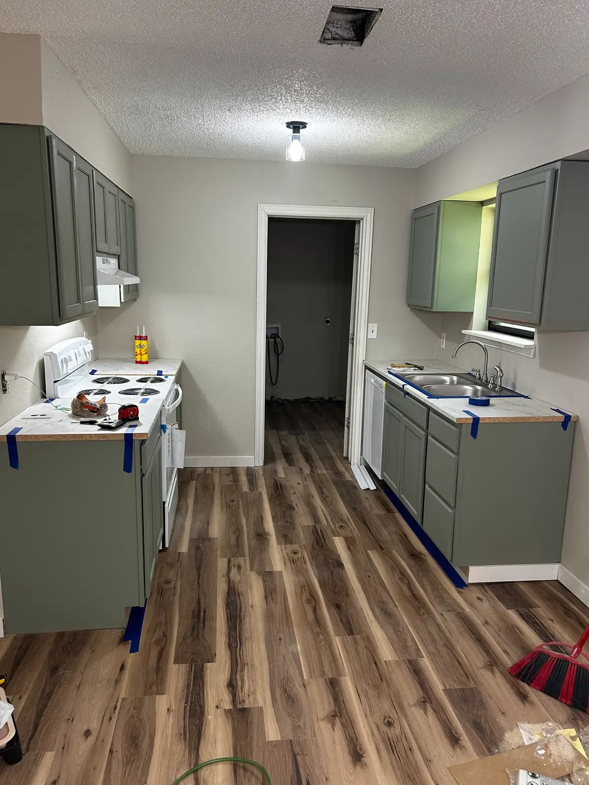 Remodeled kitchen with updated cabinets and new plank flooring