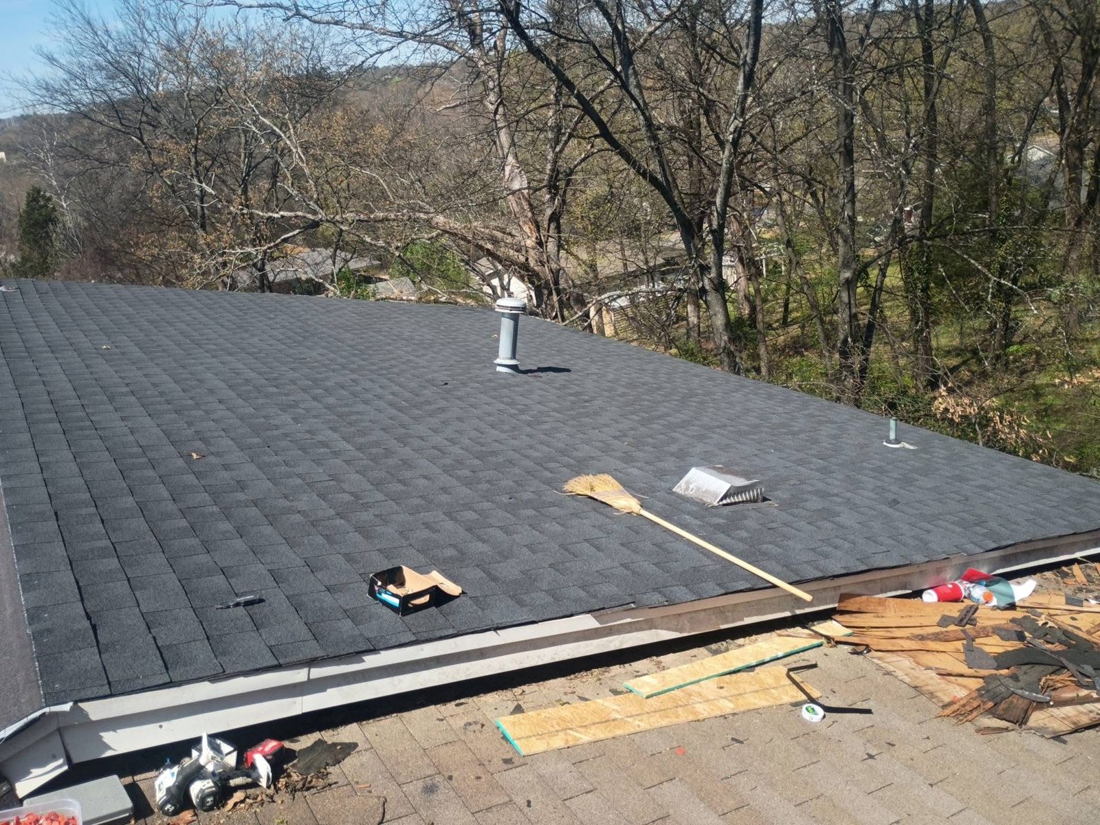The same roof finished with new dark gray architectural shingles